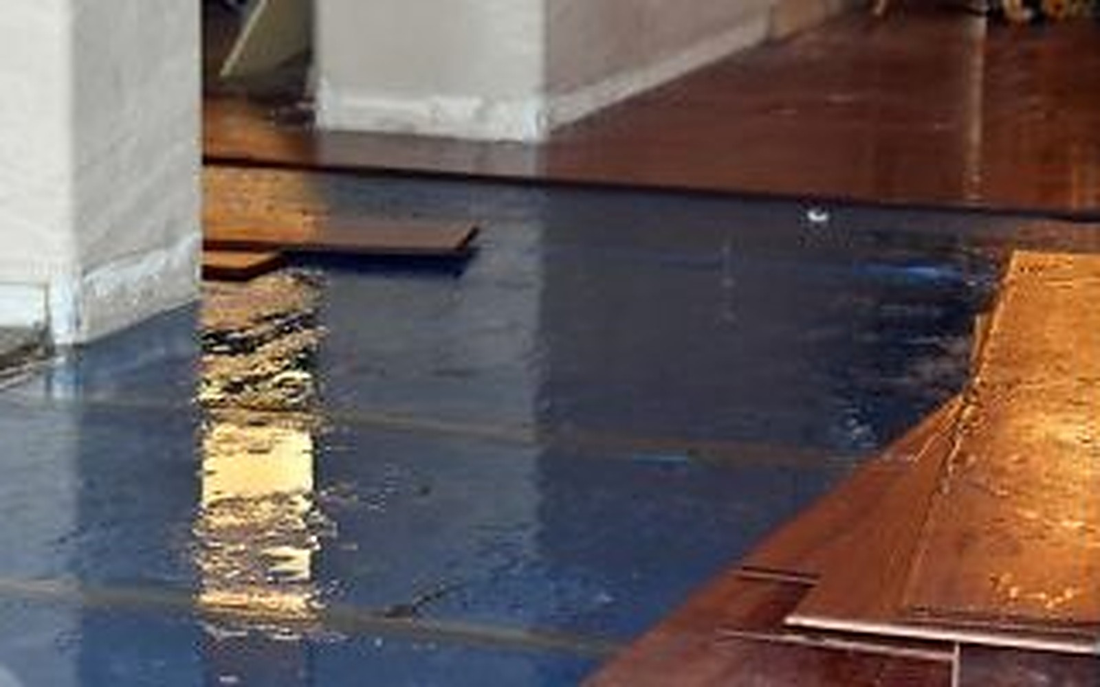 Illustrative example: the same room with standing water across the floor before water damage restoration